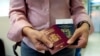 Foto de archivo. Una mujer muestra sus pasaportes. (REUTERS/Ana Maria Arevalo Gosen)